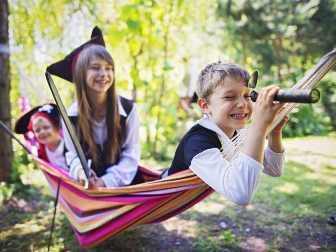 Kid pirates playing on a hammock boat